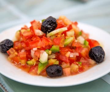 Fresh tomato salad with black olives