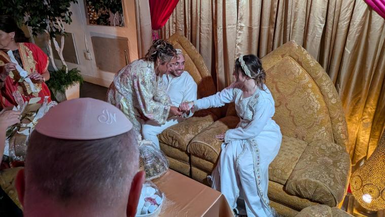 Bride and Groom at in their chairs at the Morccan Sephardic wedding