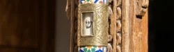 Step-by-step guide showing how to affix a Sephardic mezuzah vertically on a wooden doorpost, including marking the position, inserting the scroll, and securing the case.
